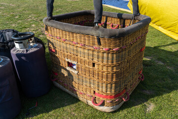 Hot air balloon woven basket for passengers and pilot. Gondola capsule suspended beneath envelope....