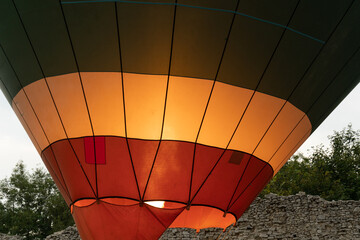 Obraz premium Hot air balloon gas burner directing fire flames into envelope. Ballooning equipment to move the balloon off the ground and into the air.