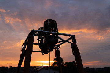 Sunset silhouette of hot air balloon gas burner. Ballooning equipment to heat up the envelope....