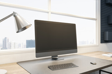 Close up of empty computer screen on wooden office desk with objects, lamp and supplies on panoramic window and city view background. Mock up, 3D Rendering.