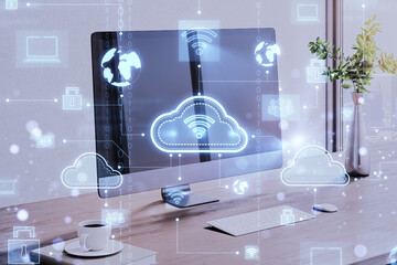 Close up of designer workplace with computer monitor and digital cloud computing hologram on blurry background. Cloud data and service concept. 3D Rendering.