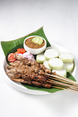 Chicken Satay or Sate Ayam is a dish of seasoned, skewered and grilled meat, served with a peanut sauce
