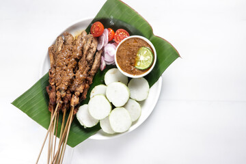 Chicken Satay or Sate Ayam is a dish of seasoned, skewered and grilled meat, served with a peanut sauce