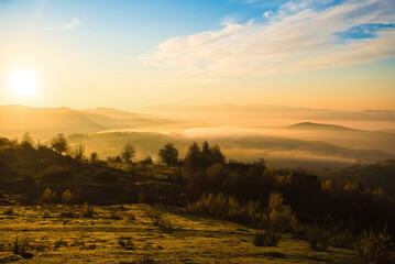 Autumn forest in morning fog.. Nature scene during sunset fog. Wooden bench in picturesque scenery. Bright sunlight. Sunrise on a sunny day, morning sunlight. Autumn background.