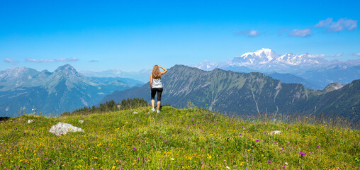 Hiker woman enjoying panoramic view of mountain