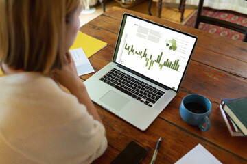 Composition of data processing on laptop over asian businesswoman in office