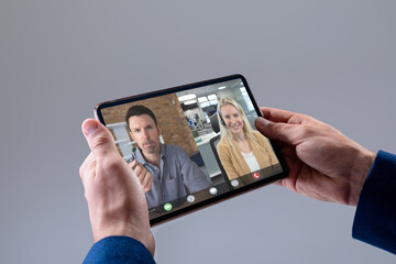 Caucasian businessman having video call with colleagues