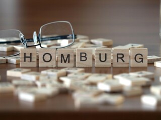 homburg word or concept represented by wooden letter tiles on a wooden table with glasses and a book