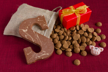 Dutch Sinterklaas tradition: A chocolate letter, a present and a bag with candy called Pepernoten.