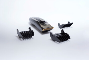 men's hair clipper on white background surrounded by cutting measure accessories. Product photography