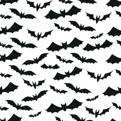 Seamless pattern with a black bats silhouettes for Halloween. Vector illustration on white background
