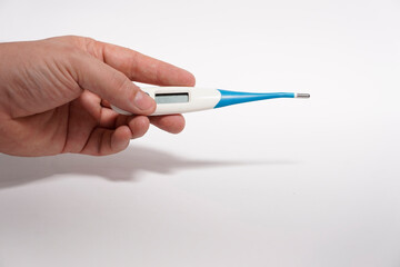 man's hand holding a baby thermometer with flexible tip