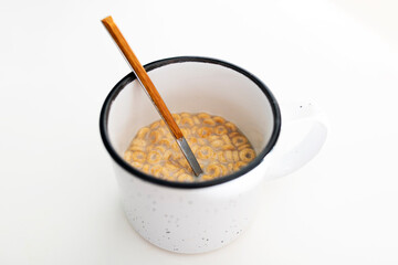 breakfast cup with oat milk and cereal on white background cheerios
