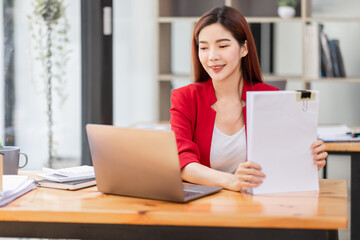 Fototapeta premium Business Documents, Auditor businesswoman checking searching document legal prepare paperwork or report for analysis TAX time,accountant Documents data contract partner deal in workplace office 