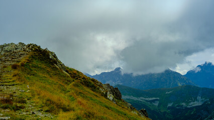Fototapeta premium low hanging clouds and fog in the mountains at a summer day