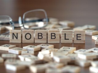 nobble word or concept represented by wooden letter tiles on a wooden table with glasses and a book