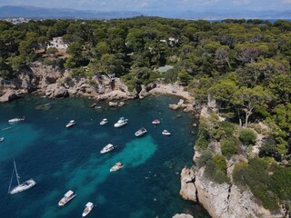 Obraz premium Aerial view of Cap d'Antibes and Billionaire's Bay. Beautiful rocky beach near coastal path on the Cap d'Antibes, Antibes, France. Drone view from above of Côte d’Azur near Juan-les-Pins and Cannes.