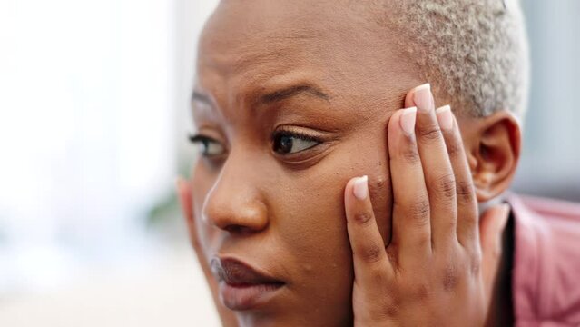 Tired African woman with headache in home, stress from mental health problem and depression after divorce in house. Sad, anxiety and fear person thinking of tax debt, marriage fail and mistake