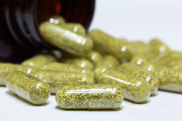 Selective focus close-up transparent natural plant capsule. Supplementary herbal food capsules. Alternative medicine, complementary medicine, healthcare concept.