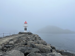 Sea lighthouse in the fog, seascape background