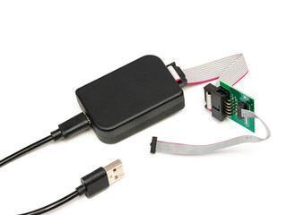 A modern programmer with a usb cable for chips and memory, with a connected flat cable and an adapter. Isolated on a white background with a light shadow.