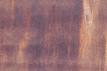 Close-up of an iron rusty wall. Corrosion covers the entire surface. Slight traces of light paint are visible. Background. Grunge. Texture.