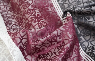 Patterned ornate style fabric in white, burgundy and dark colors for background, fashion concept, textile business advertisement, etc.