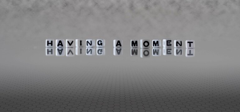 having a moment word or concept represented by black and white letter cubes on a grey horizon background stretching to infinity