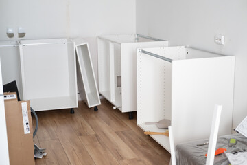 Assembling the white frames of the modular kitchen. Step by step assembly process for a modular...