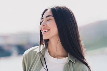 Photo of shiny adorable girlfriend wear green outfit smiling enjoying sunny weather outdoors city street