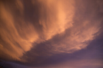 Fototapeta na wymiar Unusual dark pink layered stratus clouds, skyscape.