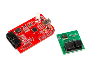 Debugger flasher board with a usb port for program chips and memory, with green adapter. Isolated on a white background.