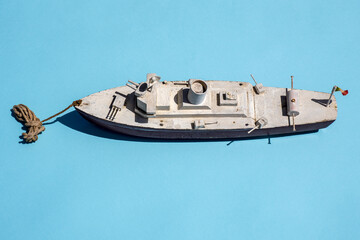 Vintage wooden toy warship on blue background © lolly66