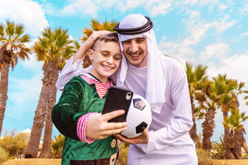 Arab businessman takes a selfie with a young fan during the time of the soccer world championships