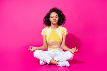 Full size photo of young attractive woman sitting relax meditation concetrated dreamy isolated on...