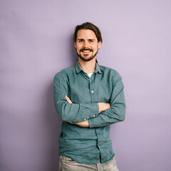laughing man with jeans shirt, copyspace with purple background