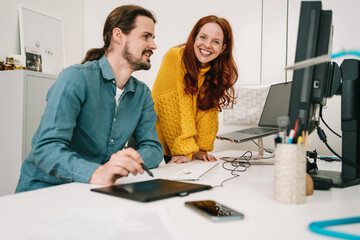 businesswoman and businessman discussing something at their workplace