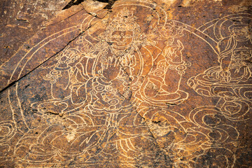 An ancient Buddha image on a stone rock. UNESCO World Heritage Site.