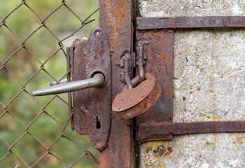 Old rusted door lock on the fence doors