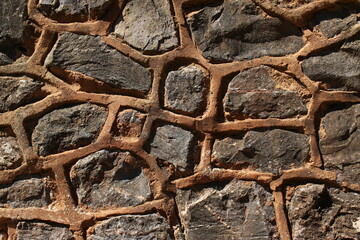 Cement pointing, stone wall texture. Non-uniform asymmetrical grey stone wall recently re-pointed...
