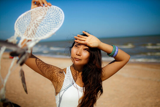 Asian Woman With Dream Catcher On Beach