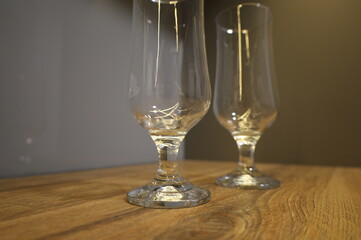 high glasses for beer, on a wooden table top