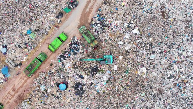 Drone flying over a huge pile of trash. workers sort out the garbage in the landfill. waste industry. Global warming. environmental pollution. 4K
