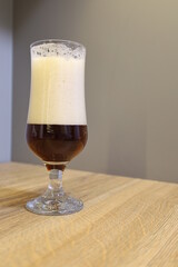 high glasses for beer, on a wooden table top