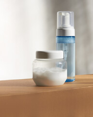 A bottle of facial foam and a jar with a hair mask .Cosmetology ,self-care