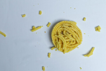 Kerupuk Mie or Noodle Crackers, which are messy on a white background, are a typical Indonesian...