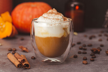A glass of autumn pumpkin latte with whipped cream and spices. Coffee with pumpkin and cinnamon on...