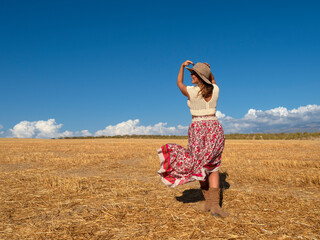 Carefree woman admiring dry field