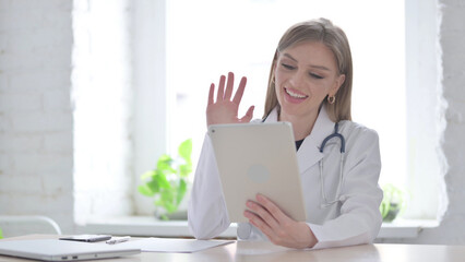 Lady Doctor making Video Call on Tablet in Clinic