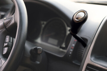 Obraz na płótnie Canvas Shift lever of the automatic transmission on the wheel. Details in the interior of the car. Selective focus.